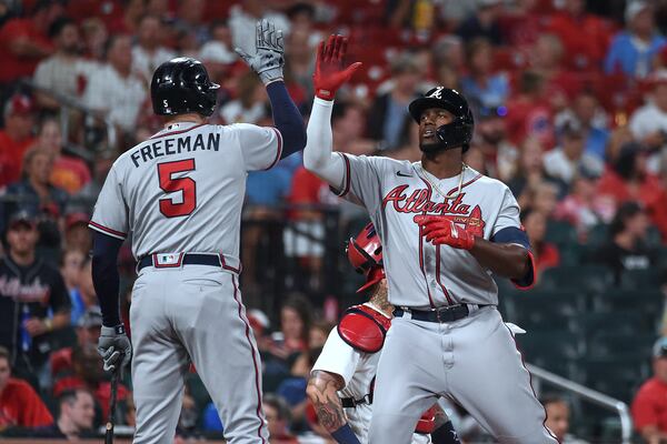 Atlanta Braves' Jorge Soler, right, is congratulated by Freddie Freeman after hitting a home run during the fifth inning of the team's baseball game against the St. Louis Cardinals on Wednesday, Aug. 4, 2021, in St. Louis. (AP Photo/Joe Puetz)