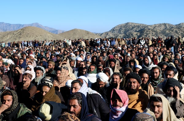 People attend the funeral prayer of Khalil Haqqani, the minister for refugees and repatriation, during his funeral procession in eastern Paktia province, Afghanistan, Thursday, Dec. 12, 2024. (AP Photo/Saifullah Zahir)