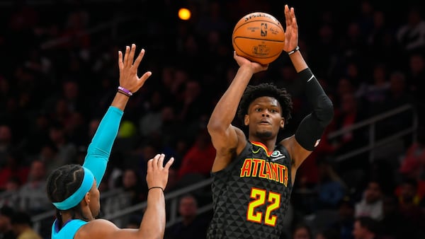 Hawks guard Cam Reddish shoots over Hornets guard Devonte' Graham during game in Atlanta. (John Amis/AP)