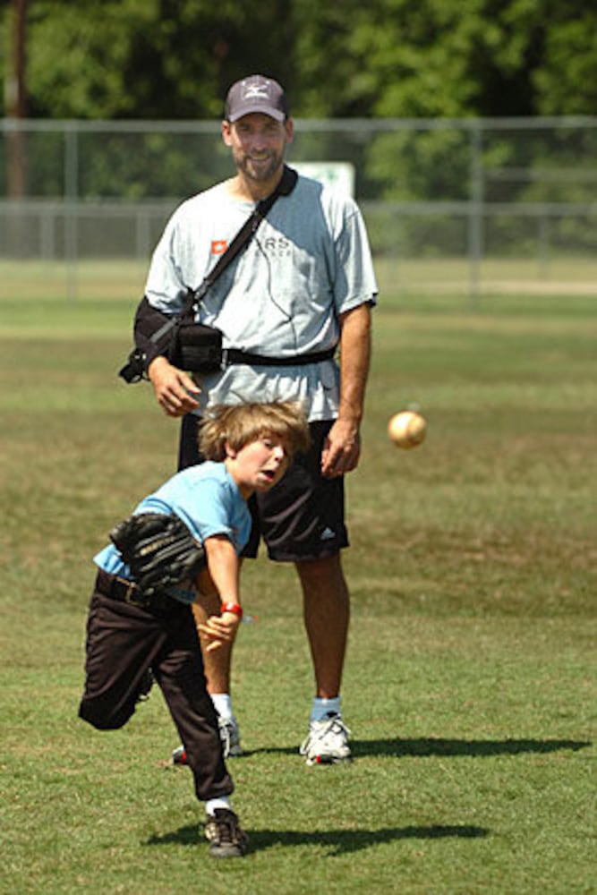 Smoltz coaches young fans at baseball camp