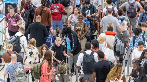 People make their way through security at Hartsfield-Jackson Atlanta International Airport Saturday after hundreds of airline flights were canceled due to a global technology outage.   (Steve Schaefer / AJC)