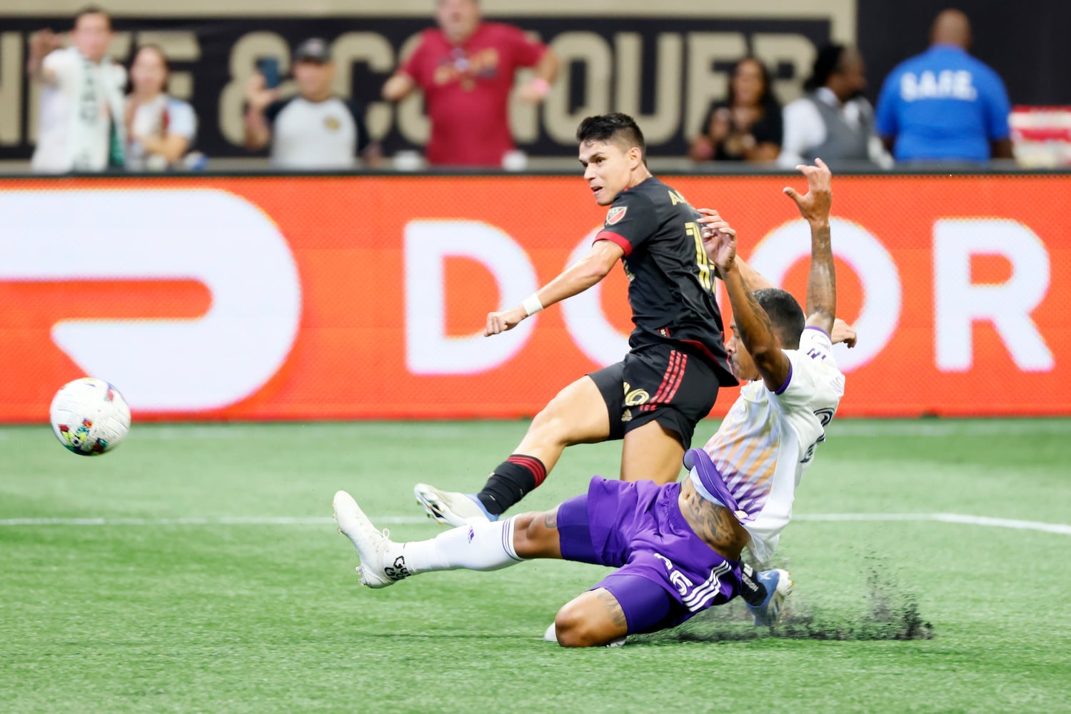 Atlanta United's Luiz Araujo takes a shot while being pressured by Orlando's Antonio Carlos during the second half of an MLS game Sunday at Mercedes-Benz Stadium. (Miguel Martinez /Miguel.martinezjimenez@ajc.com)