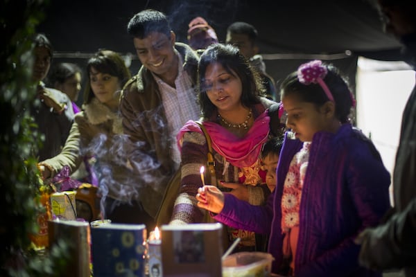 WATFORD, ENGLAND - OCTOBER 26: Worshipers gather to pray in the temple during Diwali celebrations at Bhaktivedanta Manor Hare Krishna Temple on October 26, 2014 in Watford, England. The festival of Diwali, the festival of lights, celebrates the triumph of good over evil and light over darkness. The Bhaktivedanta Manor was donated to the Hare Krishna movement in 1973 by Beatles star George Harrison. (Photo by Rob Stothard/Getty Images) The festival of Diwali, the festival of lights, celebrates the triumph of good over evil and light over darkness. (Photo by Rob Stothard/Getty Images)