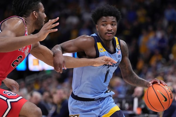 Marquette's Kam Jones tries to get past St. John's's Zuby Ejiofor during the first half of an NCAA college basketball game Saturday, Mar. 8, 2025, in Milwaukee. (AP Photo/Morry Gash)