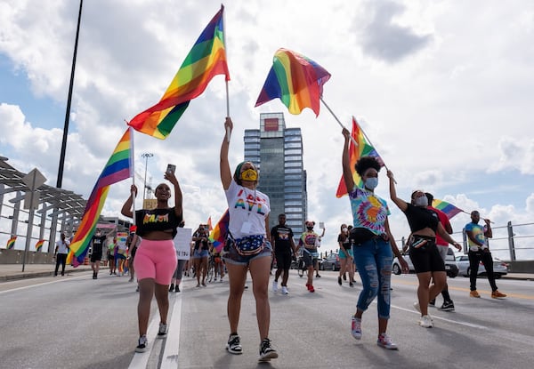 Dee Dee Tsegaye (from left), Andané Browne and Destiny Britt lead the Beauty In Colors Rally and march across the 17th Street bridge Sunday afternoon June 28, 2020. (Photo: Ben Gray for The Atlanta Journal-Constitution)