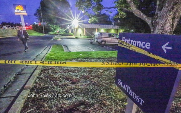 A kidnapper was killed early Wednesday after forcing a man and his teenage son from their DeKalb County apartment to a SunTrust Bank, police said. JOHN SPINK / JSPINK@AJC.COM