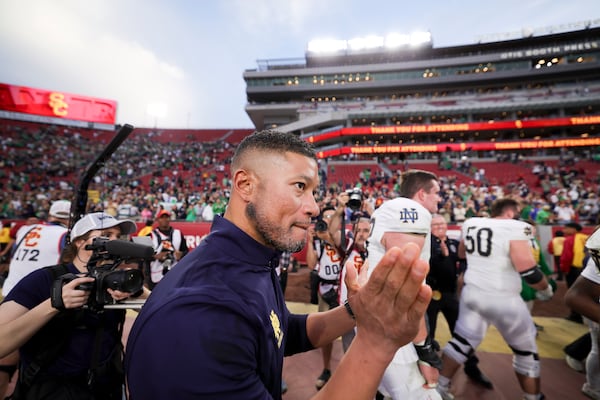 Notre Dame head coach Marcus Freeman walks off the field after the team's win against Southern California in an NCAA football game Saturday, Nov. 30, 2024, in Los Angeles. (AP Photo/Ryan Sun)