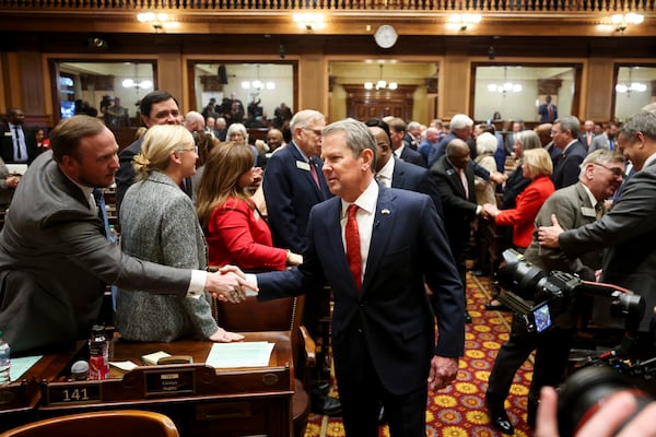 Gov. Brian Kemp greets lawmakers as he enters the House Chamber before he delivers the state of the state address in the House of Representatives at the Georgia Capitol, Thursday, Jan. 16, 2025, in Atlanta. (Jason Getz / AJC)