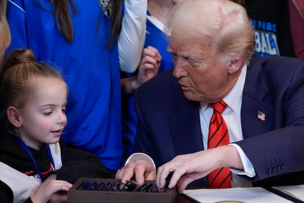 President Donald Trump talked with a visitor in the the East Room of the White House on Wednesday.