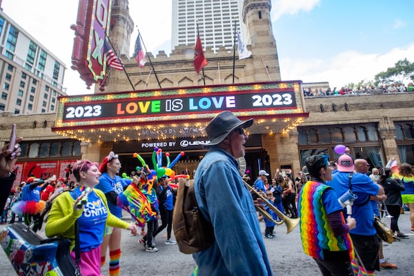 The annual Pride Parade marches up Peachtree Street past the Fox Theater on Sunday, Oct 15, 2023.  (Jenni Girtman for The Atlanta Journal-Constitution)