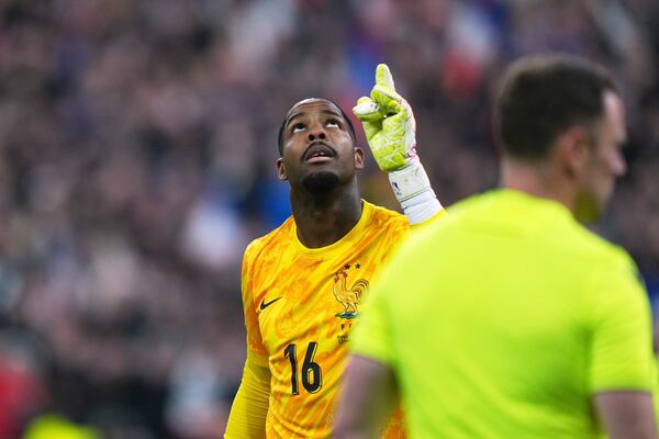 France's goalkeeper Mike Maignan reacts after saving a penalty by Croatia's Martin Baturina during the penalty shootout of the UEFA Nations League quarterfinal second leg soccer match between France and Croatia, at the Stade de France in Saint-Denis, outside Paris, Sunday, March 23, 2025. (AP Photo/Thibault Camus)