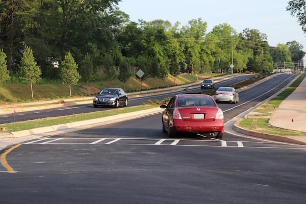 Traffic flows on the recently opened two-lane Collins Hill Extension. The extension provides a 2-mile direct commute from downtown Lawrenceville to Georgia Gwinnett College. (Tyler Wilkins / tyler.wilkins@ajc.com)