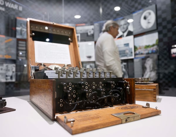 Among Lonnie Mimms' collectables is an original German Enigma machine from World War II. It's located in an exhibit dedicated to Alan Turing, the mathematician whose work work is credited with cracking the Enigma code and helping end the war.  Ryon Horne/RHORNE@AJC.COM