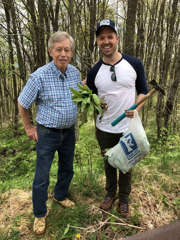 Allan Benton (left), of Benton’s Smoky Mountain Country Hams, and cookbook author Chadwick Boyd are seen foraging on the ridge of the Nantahala National Forest. Chadwick Boyd for The Atlanta Journal-Constitution