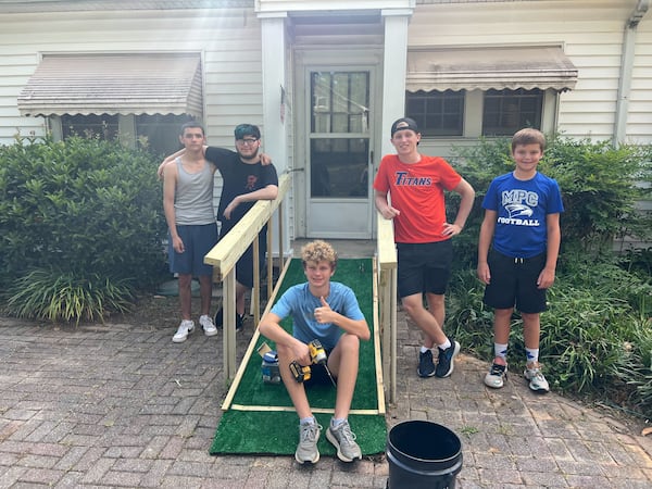 From left: Fabian Solano, Sean Salazar, Jackson Borders, Asa Brown and Major Jones help with yard work and repairs at the home of Robert Morrison, who was seriously injured by a hit-and-run driver while standing in his front yard Saturday.