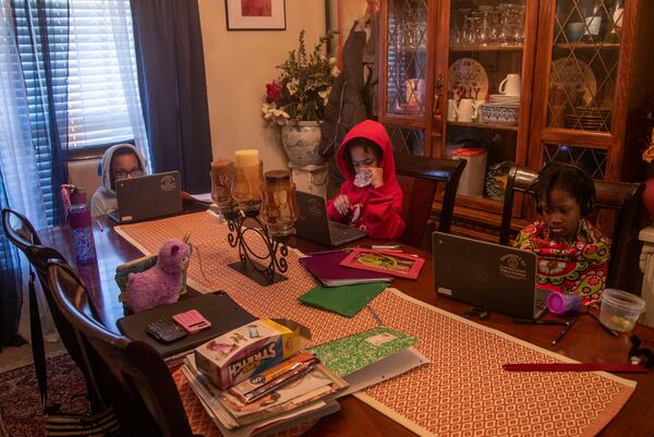 10/12/2020 - Hampton, Georgia - Sisters Cayden Dahn (from left) and MÕCayla Dahn (center) participate in virtual learning with their cousin Hajar Tyler (right) at their residence in Hampton, Monday, October 12, 2020.  (Alyssa Pointer / Alyssa.Pointer@ajc.com)