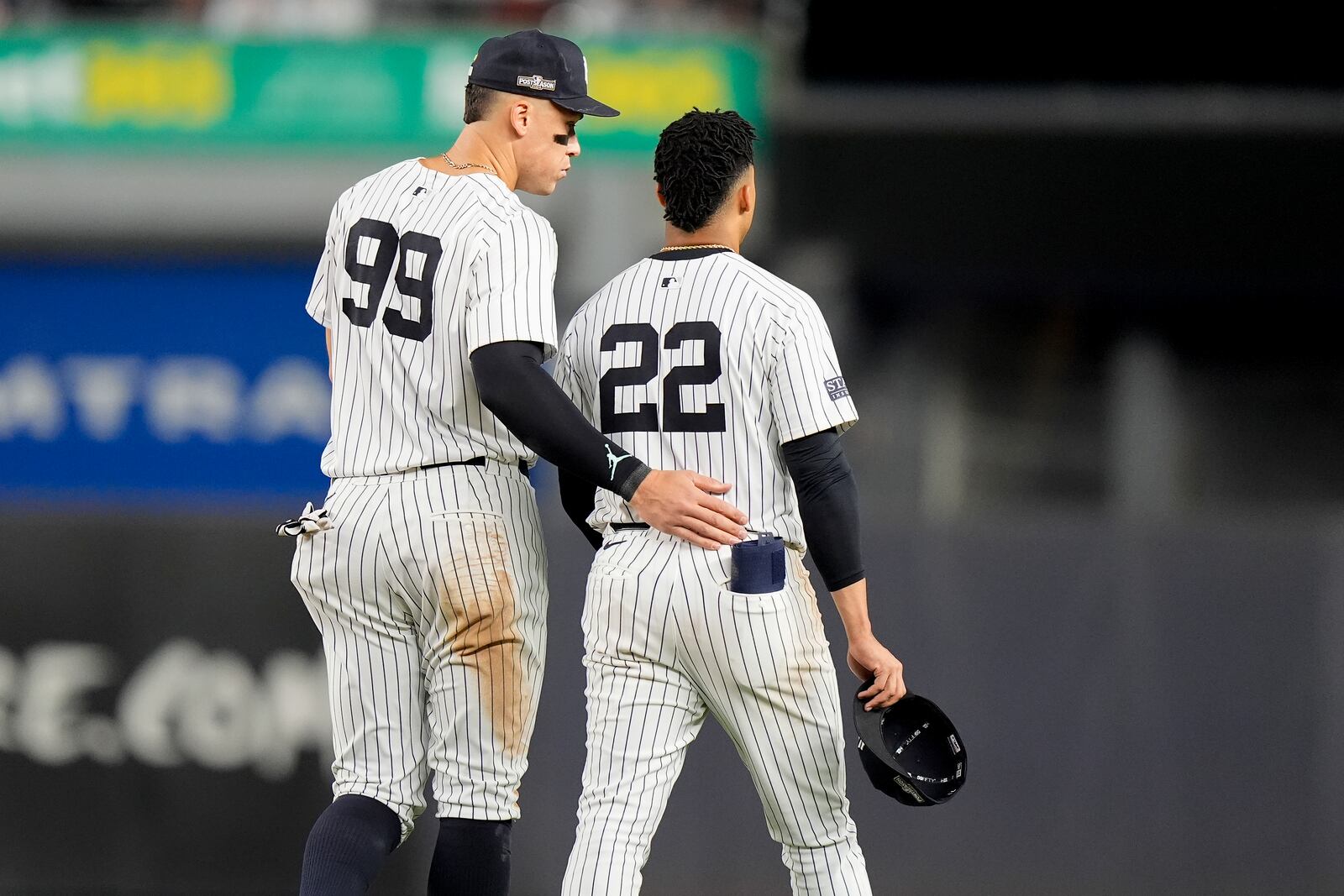 New York Yankees' Aaron Judge (99) talks with Juan Soto (22) at the end of the seventh inning of Game 2 of the American League baseball playoff series against the Kansas City Royals, Monday, Oct. 7, 2024, in New York. (AP Photo/Frank Franklin II)