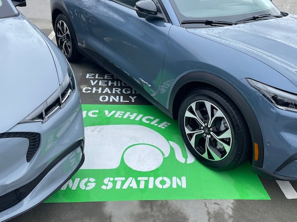 Atlanta Mayor Andre Dickens and sustainable energy leaders celebrated 21 new electric vehicle chargers at the parking garage that caters to City Hall employees on Wednesday, Feb. 19, 2025. (Riley Bunch/AJC)