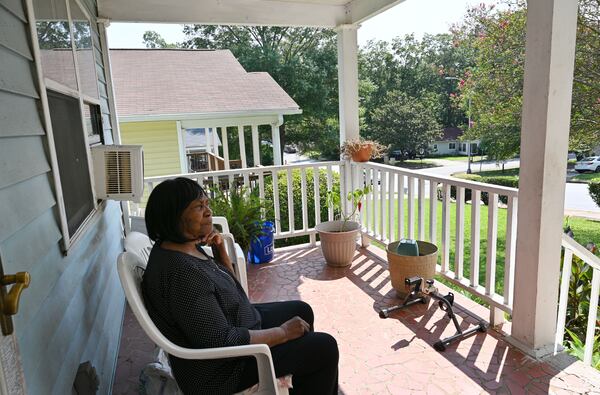 Sally Hollis sits on her porch at her Habitat home built by Jimmy and Rosalynn Carter and many volunteers in 1988, on Foote Street, Tuesday, September 12, 2023, in Atlanta. Neighbors in the 20-home cluster in the Edgewood section of Atlanta used to live in run-down apartments and rented homes, and grew weary of raising families where there was so much crime and drugs. (Hyosub Shin / Hyosub.Shin@ajc.com)