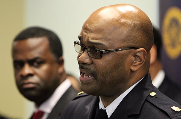 Atlanta Mayor Kasim Reed (background) listens on Dec. 22, 2010, as Atlanta Police Major Keith Meadows announces that Tamario Wise, 18, and two others have been the charged with the murder of Charles Boyer, who was killed on Nov. 22 at 609 Virginia Ave.