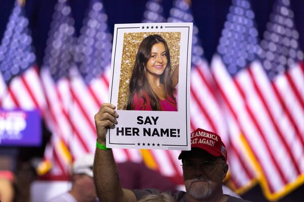 A Donald Trump supporter holds a sign with a photo of slain nursing student Laken Riley at a rally for presidential candidate and former president Donald Trump in Rome on Saturday, March 9, 2024. (Arvin Temkar / arvin.temkar@ajc.com)