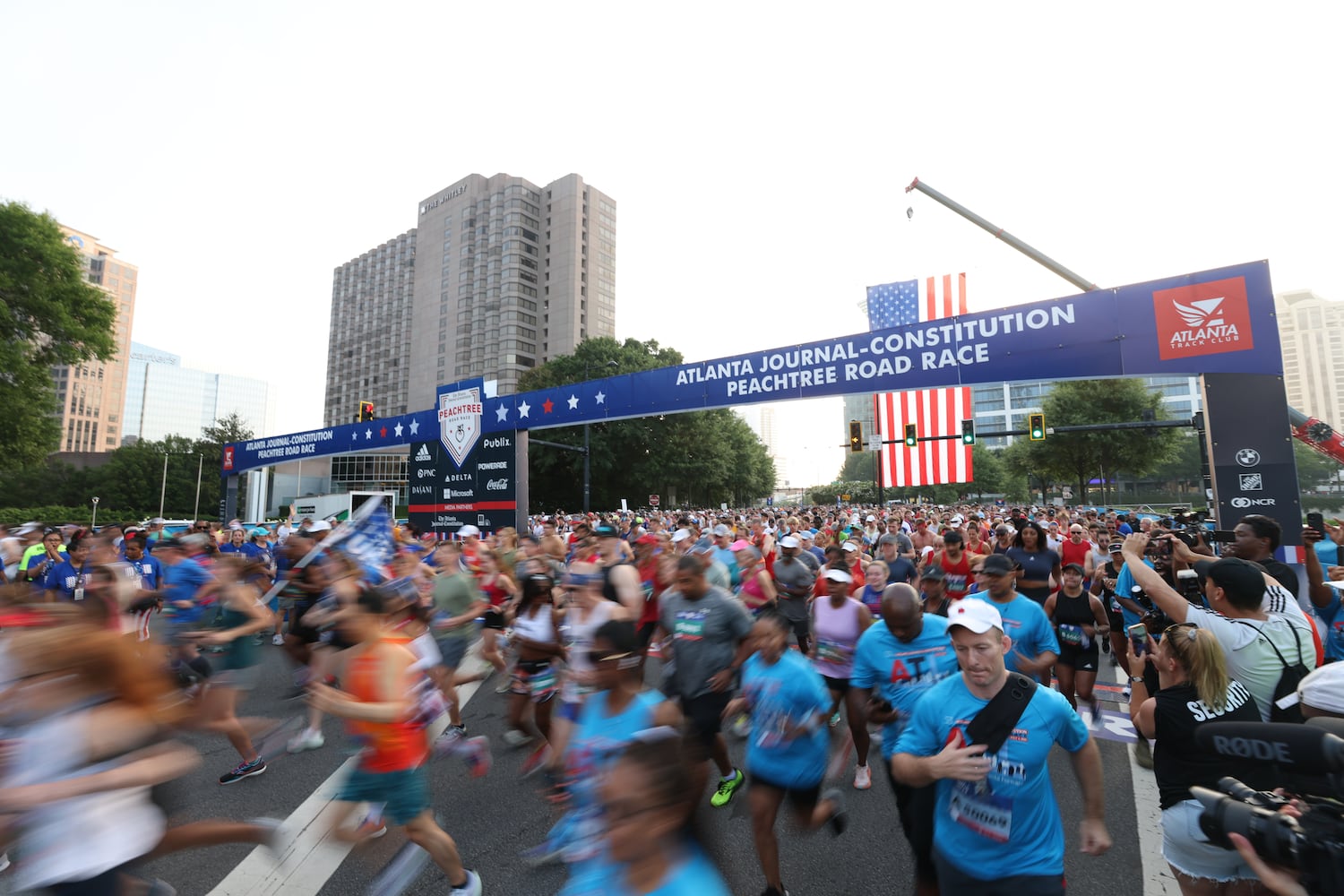 Runners take off at the start of the 53rd running of the Atlanta Journal-Constitution Peachtree Road Race in Atlanta on Monday, July 4, 2022. (Jason Getz / Jason.Getz@ajc.com)