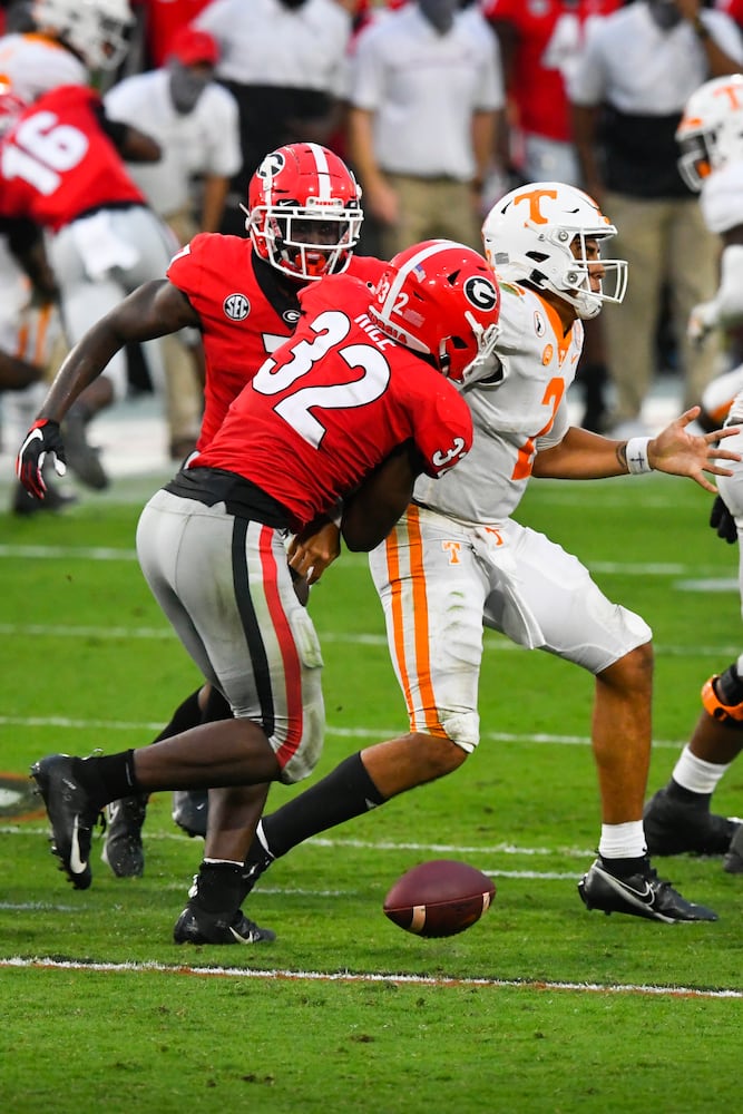 Georgia linebacker Monty Rice (32) strips the ball from Tennessee quarterback Jarrett Guarantano in the pocket during the second half of a football game Saturday, Oct. 10, 2020, at Sanford Stadium in Athens. Georgia won 44-21. JOHN AMIS FOR THE ATLANTA JOURNAL- CONSTITUTION