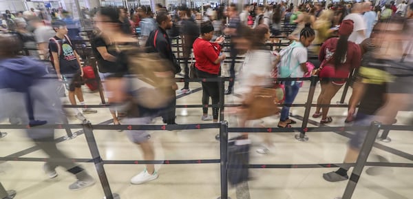 Travelers lined up in security lines at Hartsfield-Jackson International Airport. JOHN SPINK/JSPINK@AJC.COM