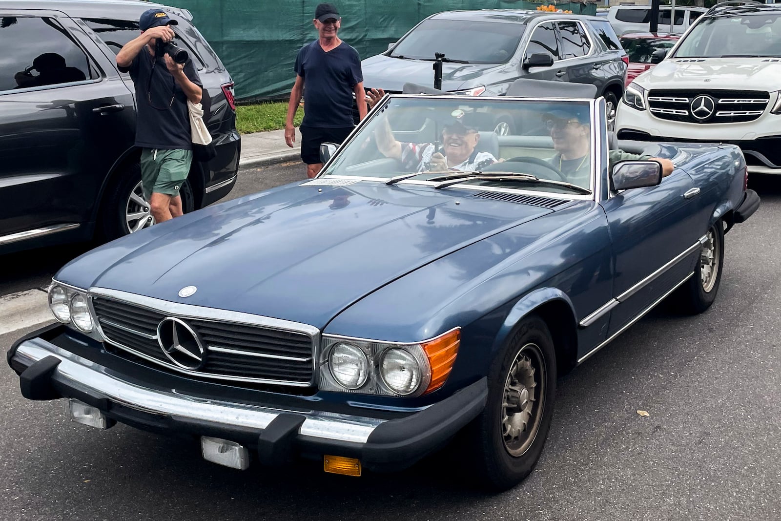 This photo provided by the Financial Times shows Rudy Giuliani in the passenger seat of a Mercedes convertible at the same polling place where Donald Trump cast his ballot on Election Day, Tuesday, Nov. 5, 2024, in Palm Beach, Fla. (Alex Rogers/Financial Times via AP)