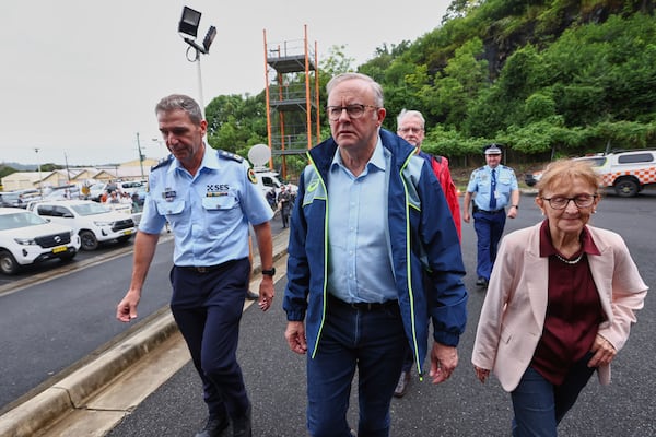 Australian Prime Minister Anthony Albanese, centre, arrives at a State Emergency Service centre in Lismore, Australia, Monday, March 10, 2025. (Jason O'Brien/AAP Image via AP)