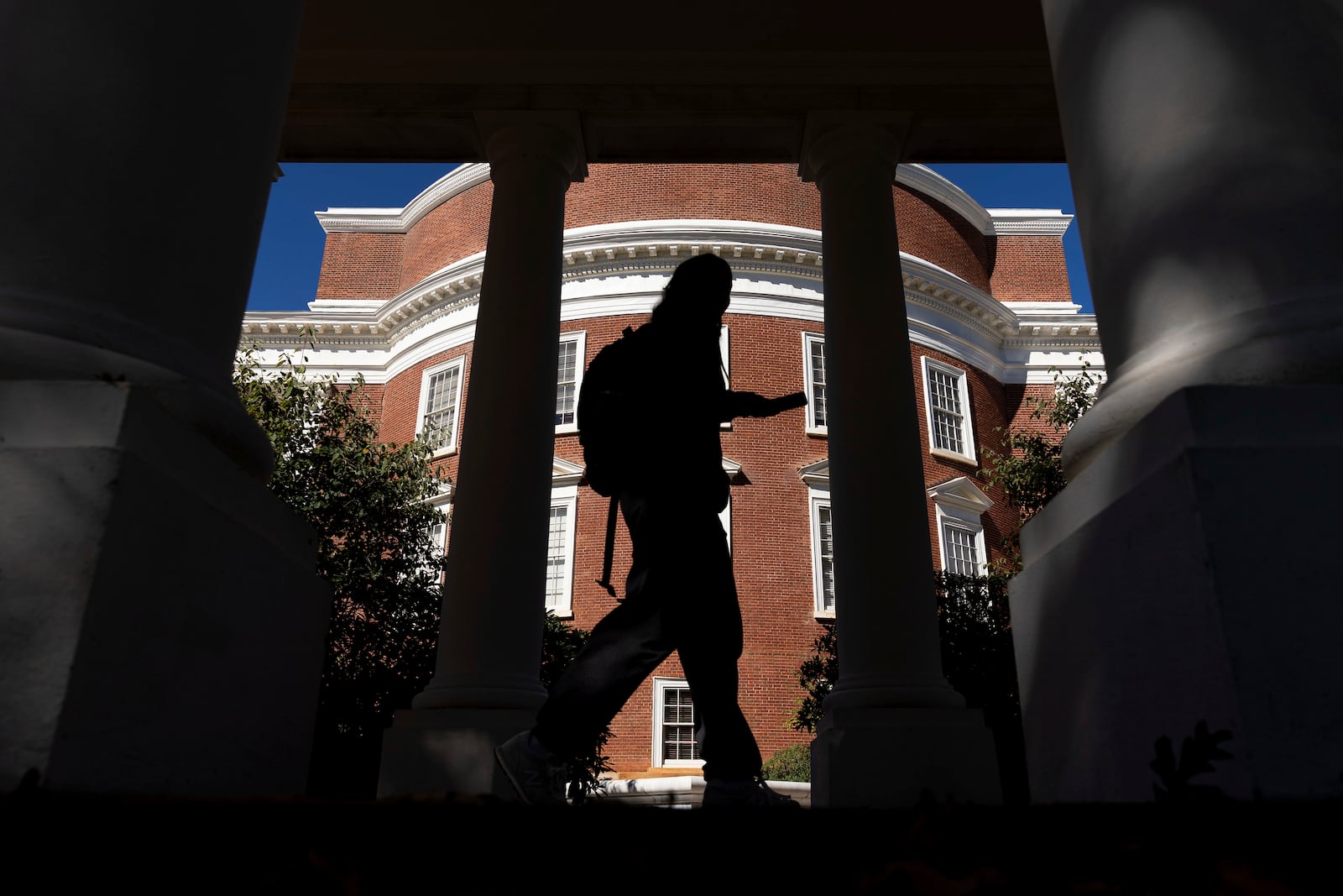 A student walks past the Rotunda at the University of Virginia in Charlottesville, Va., Friday, Oct. 11, 2024. (AP Photo/Ryan M. Kelly)