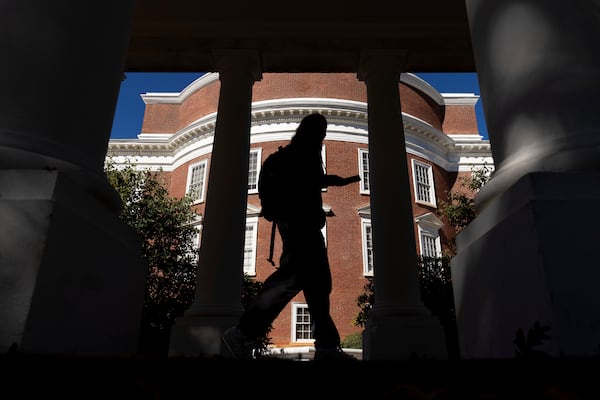 A student walks past the Rotunda at the University of Virginia in Charlottesville, Va., Friday, Oct. 11, 2024. (AP Photo/Ryan M. Kelly)