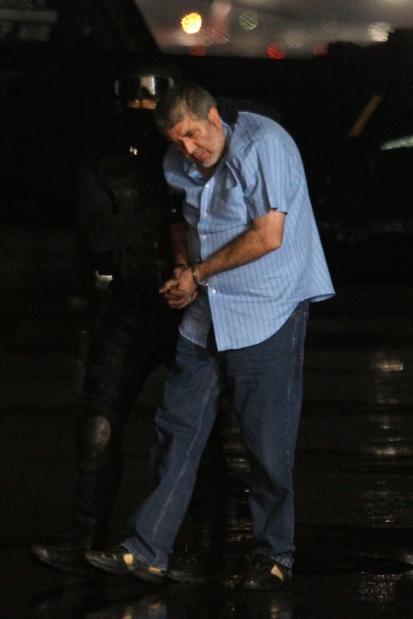 FILE - Vicente Carrillo Fuentes, the purported leader of the Juarez cartel, is led to a helicopter after his arrest at the hangar of the Mexican Attorney Generals Office in Mexico City, Oct. 9, 2014. (AP Photo, File)