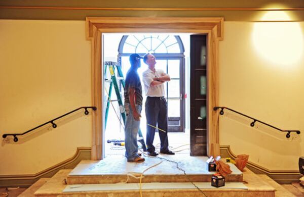 Rodney Cook Jr. (right), who conceived the Millennium Gate project at Atlantic Station, takes a look around the museum that the new monument house with project superintendent Fred Allen. The museum, which celebrates Atlanta's history tells the story of the city through the personal perspective of Cook, whose family name is deeply rooted here.