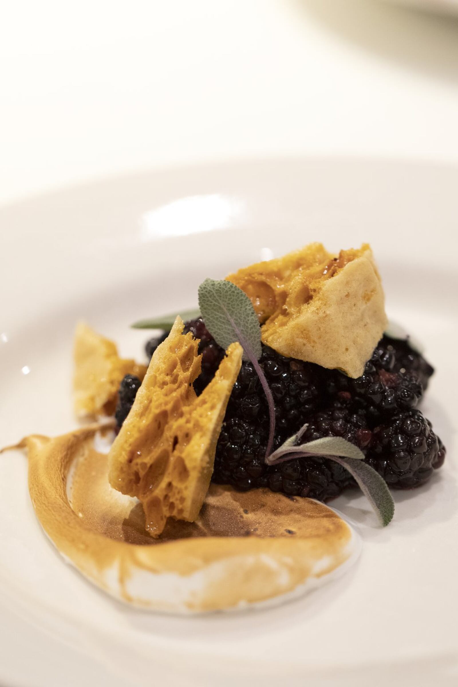 Bees were the center of attention at a recent four-course fundraising dinner at Bacchanalia for the Whole Kids Foundation bee grant program, which supports educational beehives at schools and nonprofit organizations. Pictured is a dessert of blackberries macerated in black sage honey with fresh purple sage and a smear of meringue. CONTRIBUTED BY LEAH ROTH PHOTOGRAPHY