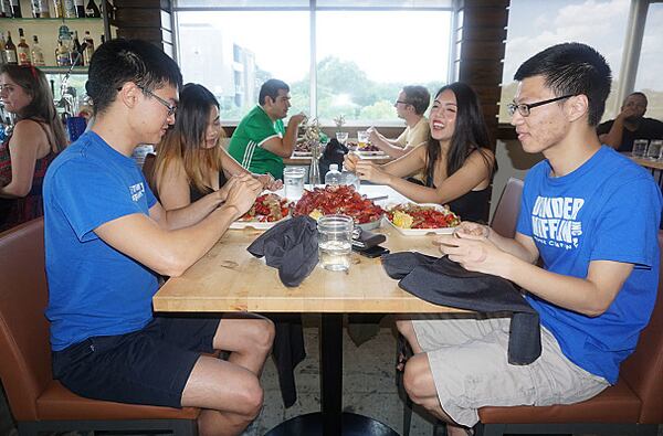 Jonathan Lian, Kimanh Le, Xunjie Zhou and Duyen Ho enjoy crawfish at the Reddit meetup.