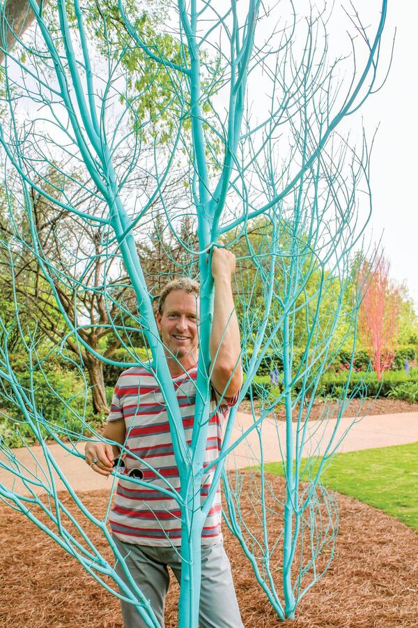 Adam Schwerner, director of horticulture at Disneyland, is taking a vacation in Atlanta and doing what he likes to do best, which is create art. His installation at the Atlanta Botanical Garden hangs orchids from chandeliers, paints a few thousand gourds bright red and dots the grounds with trees painted in ice cream colors. CONTRIBUTED BY ATLANTA BOTANICAL GARDEN