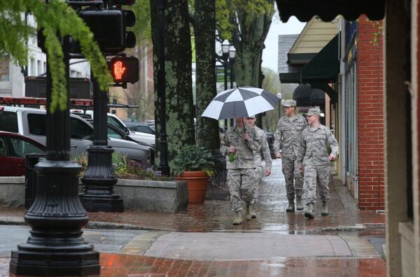 U.S. Army officers walk down West Park Square in Marietta on Wednesday during the rain. HENRY TAYLOR / HENRY.TAYLOR@AJC.COM