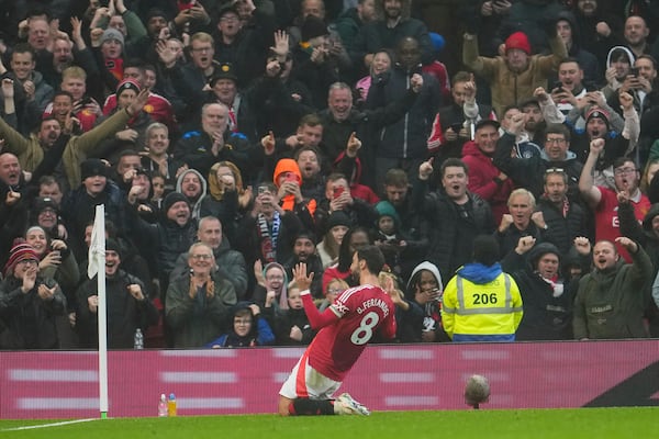 Manchester United's Bruno Fernandes celebrates after scoring his side's first goal during the English Premier League soccer match between Manchester United and Leicester City, at the Old Trafford stadium in Manchester, England, Sunday, Nov.10, 2024. (AP Photo/Jon Super)