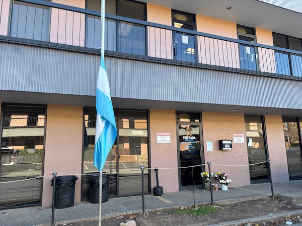 The Honduran flag was lowered to half-staff in Doraville, a day after a shooting that left security guard Jesus Loera dead and another person injured. (Jozsef Papp / AJC)