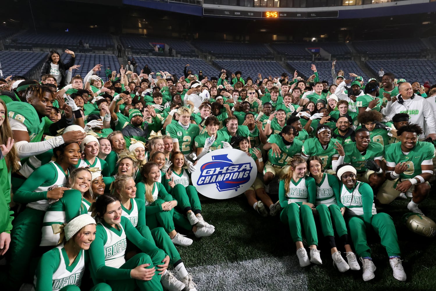 Buford players and staff pose for a group photograph after their 21-20 win against Langston Hughes in the Class 6A state title football game at Georgia State Center Parc Stadium Friday, December 10, 2021, Atlanta. JASON GETZ FOR THE ATLANTA JOURNAL-CONSTITUTION