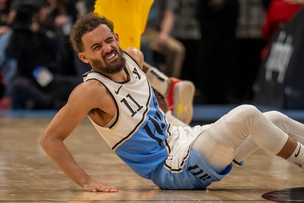 Atlanta Hawks guard Trae Young (11) falls from an injury during the second half of an NBA basketball game between the Indiana Pacers, Saturday, Mar. 8, 2025, in Atlanta. (AP Photo/Erik Rank)