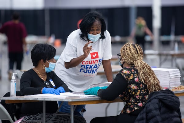 People recount ballots from the 2020 presidential election on Sunday, Nov. 15, 2020, in Stonecrest, Georgia. (Rebecca Wright for the Atlanta Journal-Constitution)