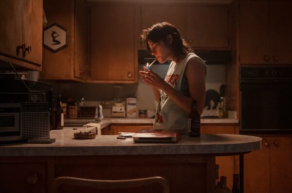 This image released by A24 shows Kristen Stewart in a scene from "Love Lies Bleeding." (Anna Kooris/A24 via AP)