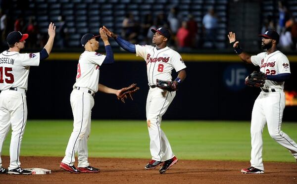 Atlanta Braves' Justin Upton (8) and Jason Heyward (22), greet Andrelton Simmons (19) and Phil Gosselin after the ninth inning of a baseball game against the Oakland Athletics Sunday, Aug. 17, 2014, in Atlanta. Atlanta won 4-3 and swept the series. (AP Photo/David Tulis) Three of these guys are already gone. (AP photo/David Tulis)