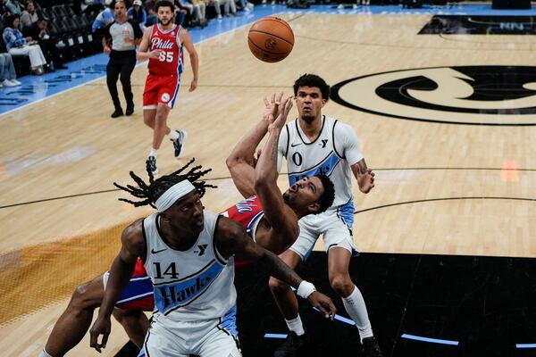 Philadelphia 76ers guard Quentin Grimes (5) falls to the court shooting against the Atlanta Hawks during the first half of an NBA basketball game, Sunday, March 23, 2025, in Atlanta. (AP Photo/Mike Stewart)