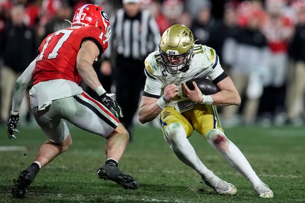 Georgia Tech quarterback Haynes King (10) runs against Georgia defensive back Dan Jackson (17) during the second half of an NCAA college football game, Saturday, Nov. 30, 2024, in Athens, Ga. (AP Photo/Mike Stewart)