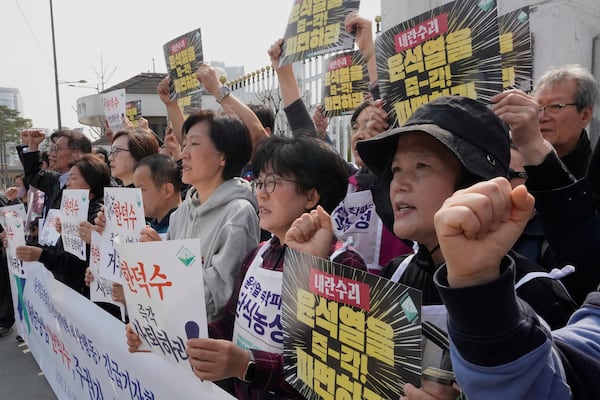 Protesters stage a rally calling for South Korean acting President Han Duck-soo to step down in front of the Government Complex in Seoul, South Korea, Monday, March 24, 2025. The banners read "Dismiss Yoon Suk Yeol and Han Duck-soo." (AP Photo/Ahn Young-joon)