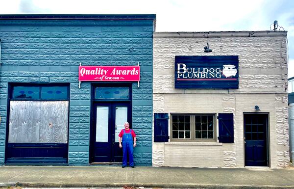 Blake Hawkins, owner of Grayson Farmacy, stands outside the future site of his business at 412 Grayson Parkway. The buildings were most recently a plumbing company and trophy shop. (Courtesy of Grayson Farmacy)