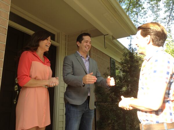 Aven Woods and Phillip Clay Barbosa await the big reveal for a future episode of "Property Brothers" with Jonathan Scott (right). CREDIT: Rodney Ho/rho@ajc.com